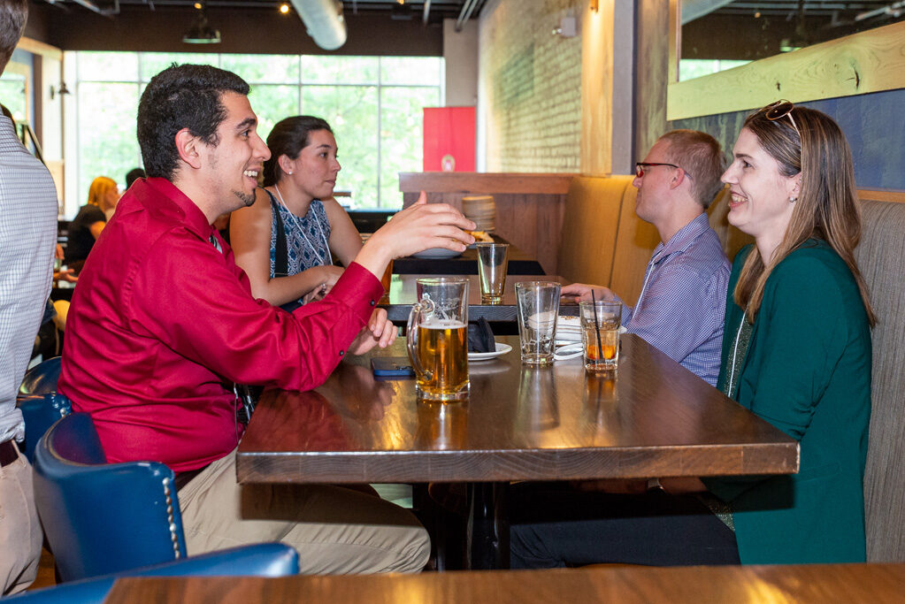 UWPharm-Coopers_2022__DSC4070_030 Alumni and attendees speaking together at Cooper's Tavern