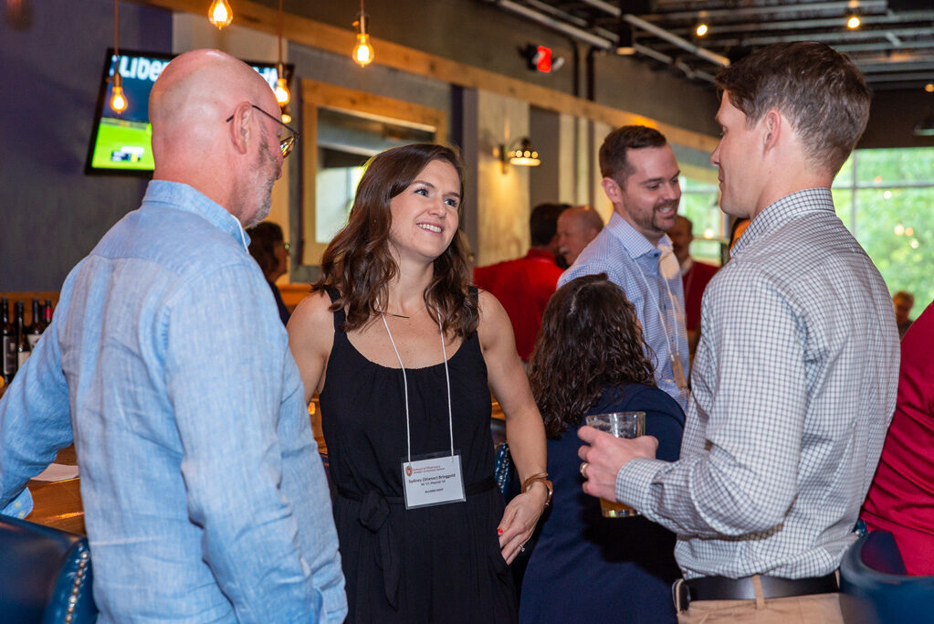 UWPharm-Coopers_2022__DSC4071_031 Alumni and attendees speaking together at Cooper's Tavern