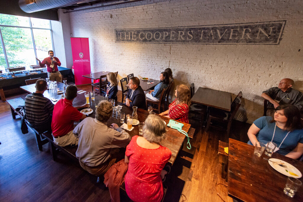 UWPharm-Coopers_2022__DSC4106_067 Pharm staff speaking to alumni attendees at Cooper's Tavern