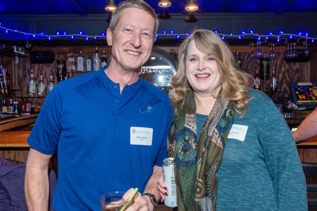 Mike and Denise Kachel standing at the bar with drinks in hand