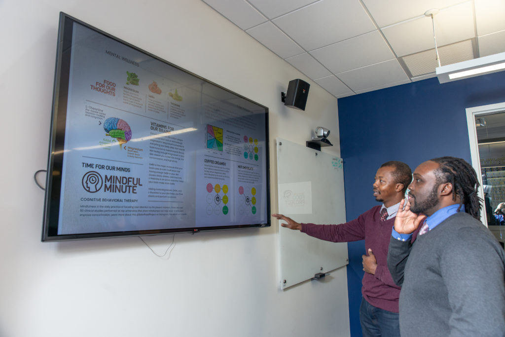 UWPharm-Satori-11262018-145 Kwadwo Owusu-Ofori and Walter Matthews looking at infographic detailing purpose behind their product
