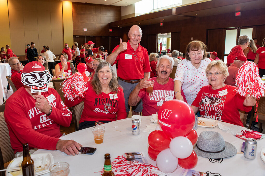 UWPharm-Tailgate_09172022_012 A group of alumni smile and laugh at the Tailgate.