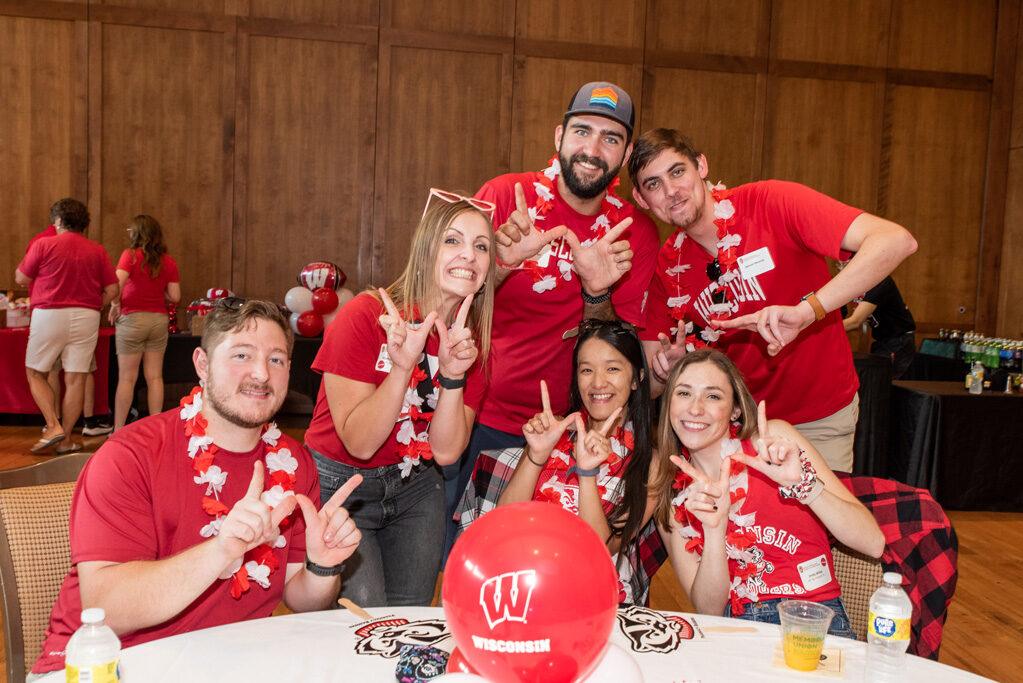 UWPharm-Tailgate_09172022_025 A group of recent School of Pharmacy alums pose with "W" hands.