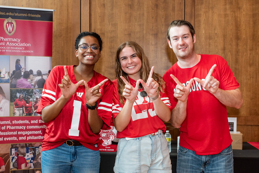 UWPharm-Tailgate_09172022_034 PharmD students pose with "W" hands.