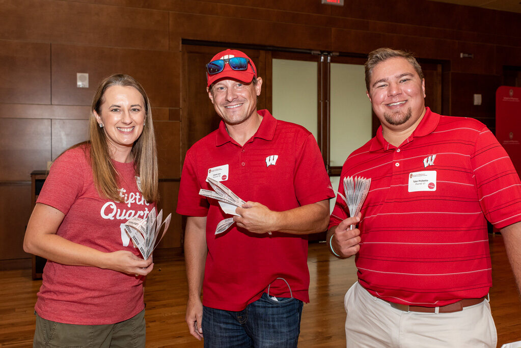 UWPharm-Tailgate_09172022_046 Jason Lau, Tyler Prickette, and Jason Lau, Tyler Prickette, and Jenny Tempelis smile with raffle tickets. smile with raffle tickets.