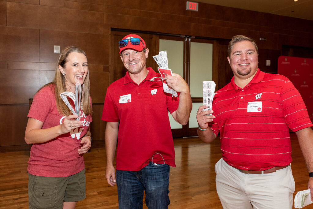 UWPharm-Tailgate_09172022_047 Jason Lau, Tyler Prickette, and Jenny Tempelis smile with raffle tickets.