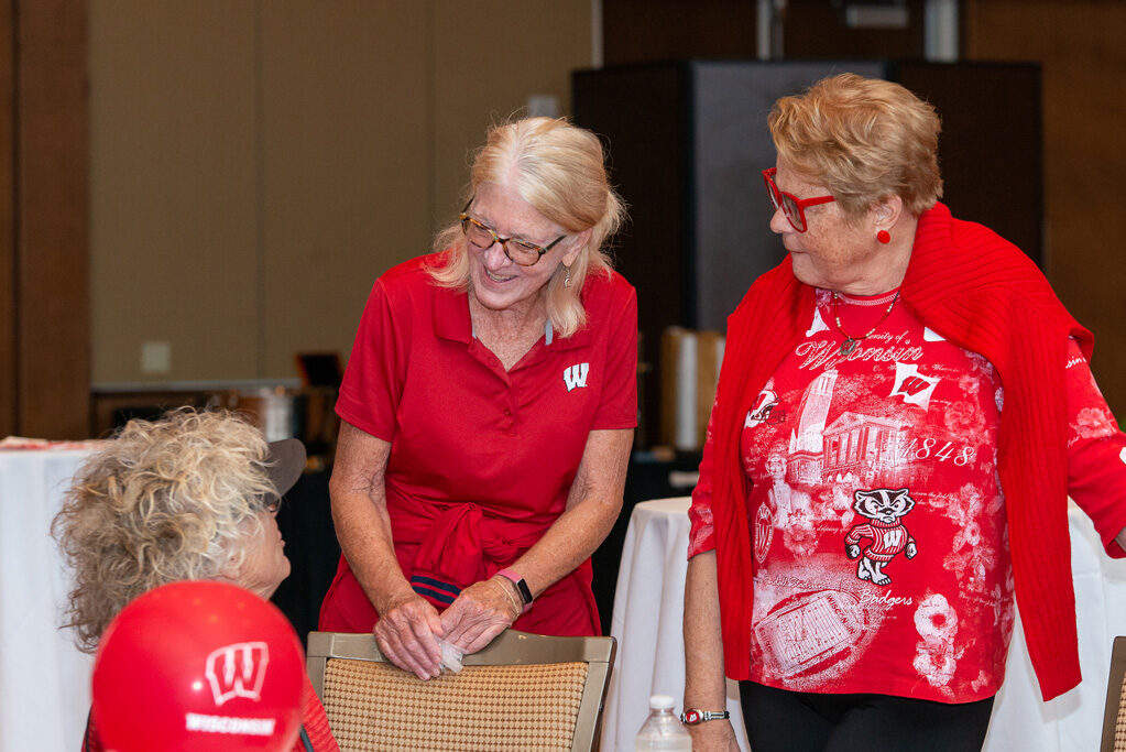 UWPharm-Tailgate_09172022_051 A group of older female alumni speak during the viewing party.