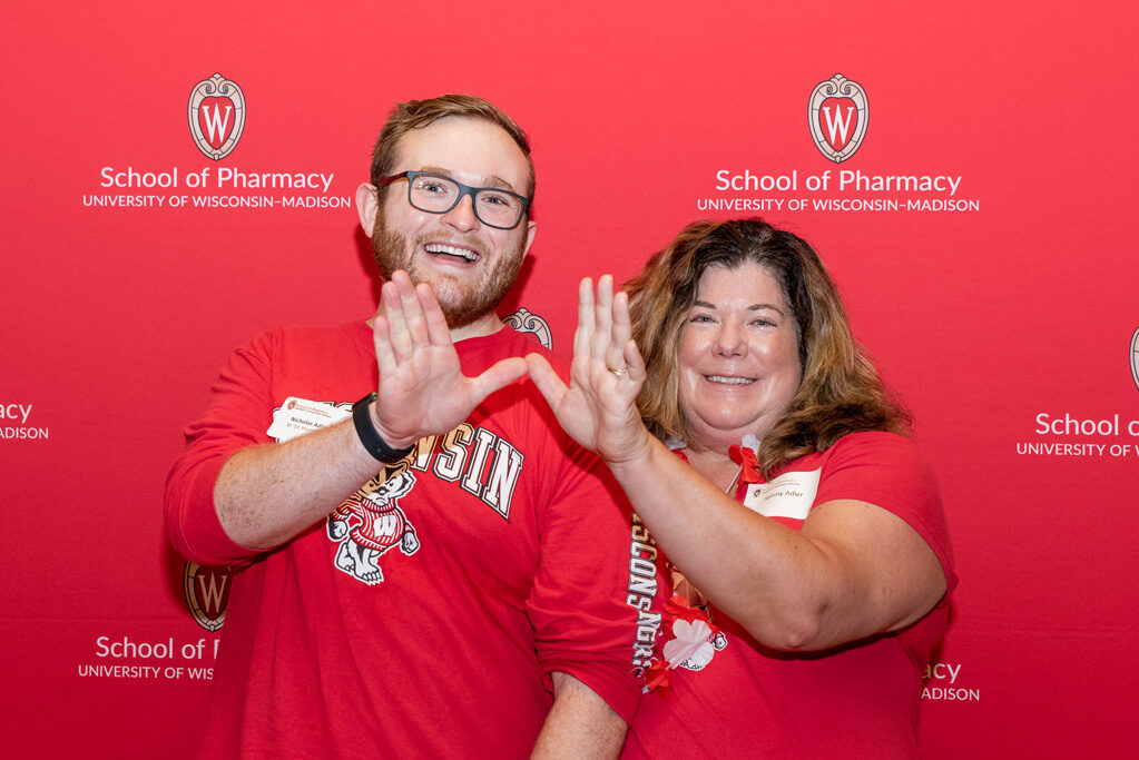 UWPharm-Tailgate_09172022_066 Nicholas and Terry Adler pose with their hands held in a "W"
