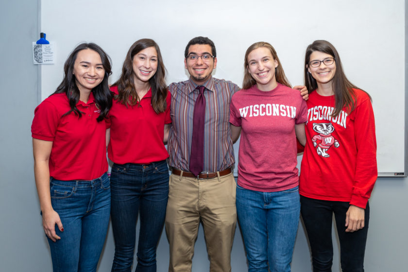 Event coordinators and participants arm-in-arm for a group photo
