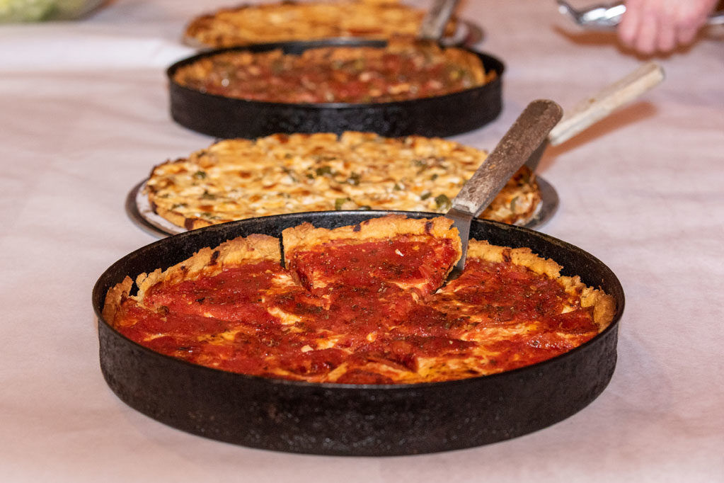 An array of pizzas laying out on table for event