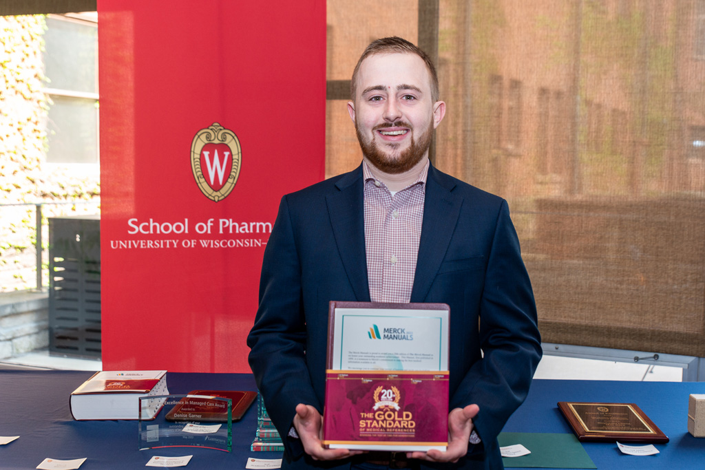 UWPhrmAward_2022_048 UW Pharm Award recipient holding the Merck Manual