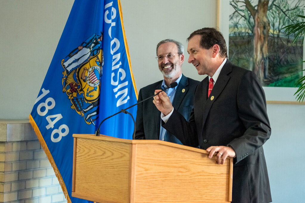 UWPhrmAward_2022_089 Dave Mott smiling with another faculty member at podium