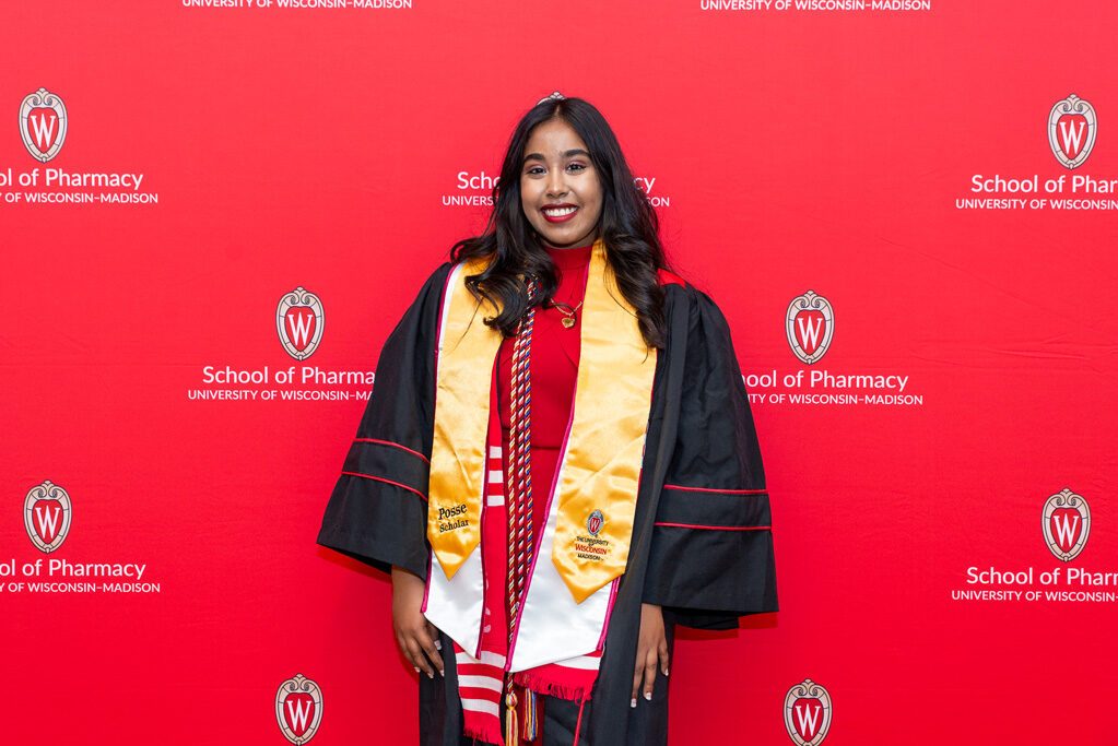 UWPhrmToxAw_2022_015 PharmTox Posse Scholar in front of red backdrop