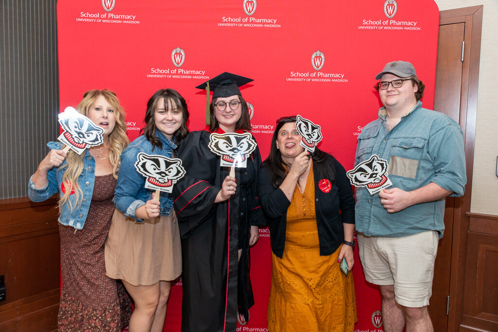 UWPhrmToxAw_2022_039 PharmTox student with her family in front of red backdrop