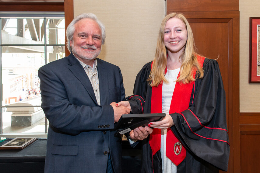 UWPhrmToxAw_2022_094 Graduate student holding a picture frame with prof. Jeffrey Johnson