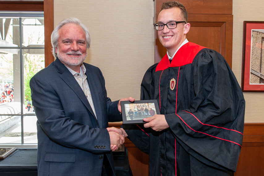 UWPhrmToxAw_2022_095 Graduate student holding a picture frame with prof. Jeffrey Johnson