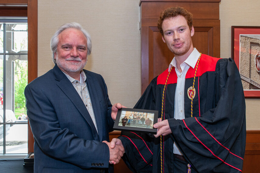 UWPhrmToxAw_2022_097 Graduate student holding a picture frame with prof. Jeffrey Johnson