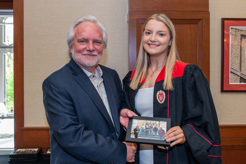 UWPhrmToxAw_2022_101 Graduate student holding a picture frame with prof. Jeffrey Johnson