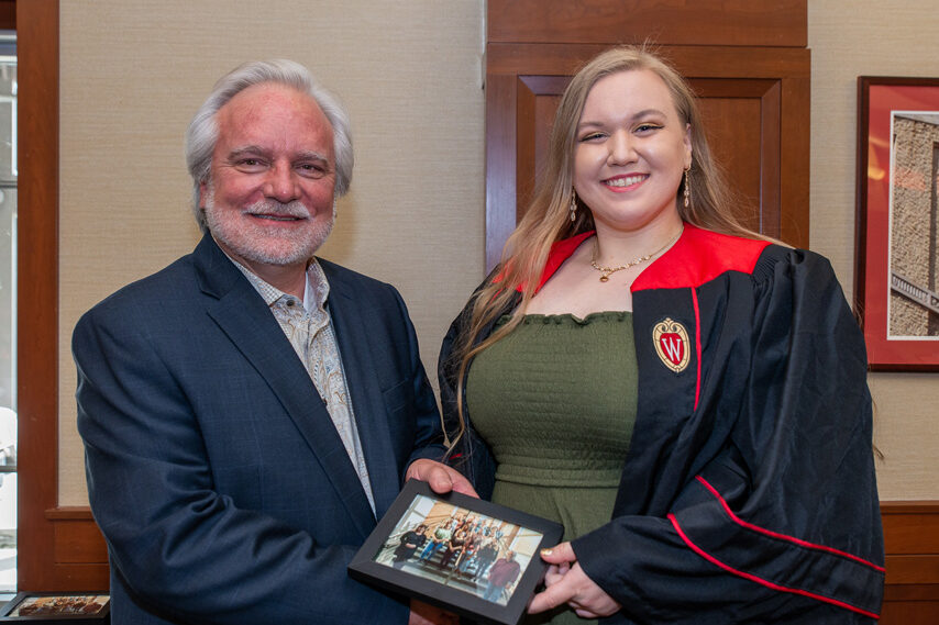 UWPhrmToxAw_2022_103 Graduate student holding a picture frame with prof. Jeffrey Johnson