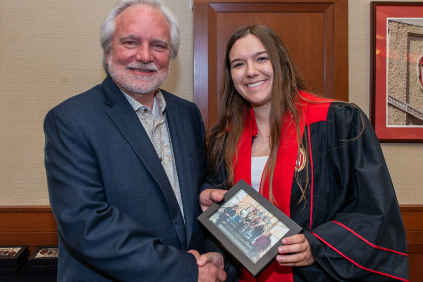 UWPhrmToxAw_2022_105 Graduate student holding a picture frame with prof. Jeffrey Johnson