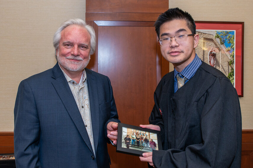UWPhrmToxAw_2022_107 Graduate student holding a picture frame with prof. Jeffrey Johnson