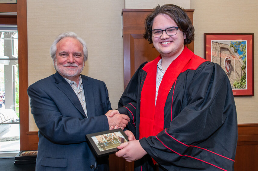 UWPhrmToxAw_2022_109 Graduate student holding a picture frame with prof. Jeffrey Johnson