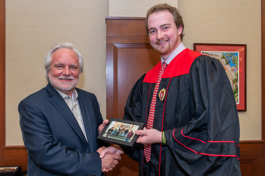 UWPhrmToxAw_2022_113 Graduate student holding a picture frame with prof. Jeffrey Johnson
