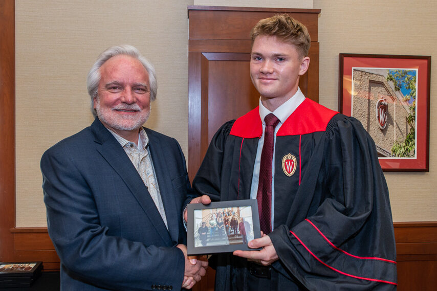 UWPhrmToxAw_2022_115 Graduate student holding a picture frame with prof. Jeffrey Johnson