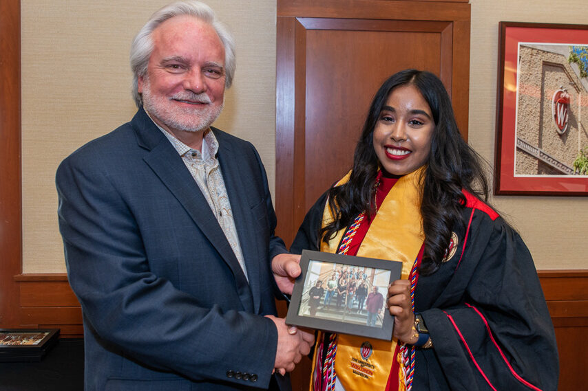UWPhrmToxAw_2022_117 Graduate student holding a picture frame with prof. Jeffrey Johnson