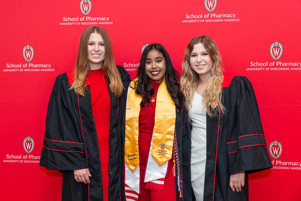 UWPhrmToxAw_2022_191 Graduated Pharm students in front of red backdrop