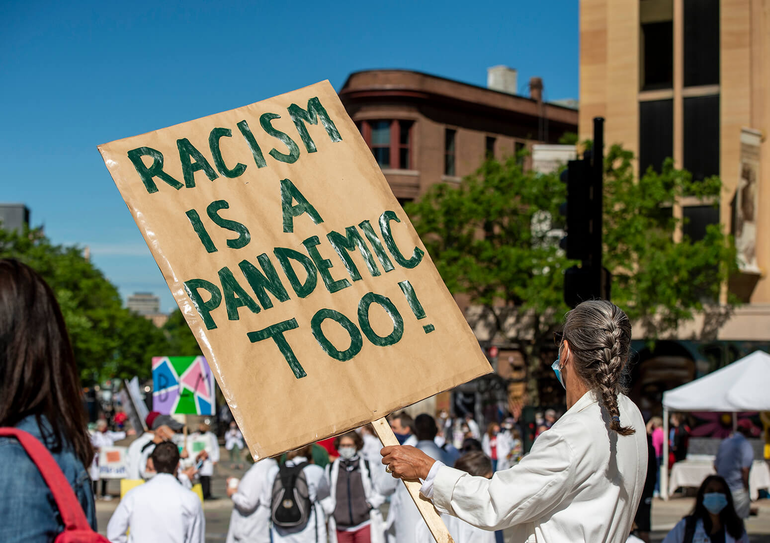 WC4BL_0620_DSC1878 Woman in white coat and mask with sign reading "Racism is a pandemic too"