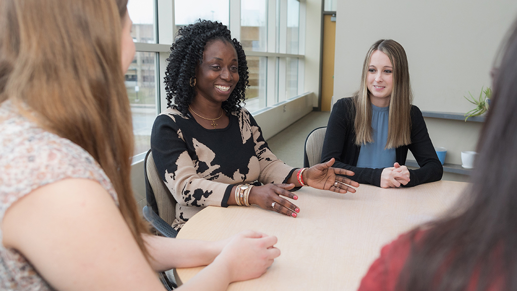 Olufunmilola Abraham speaking at a round table with students.