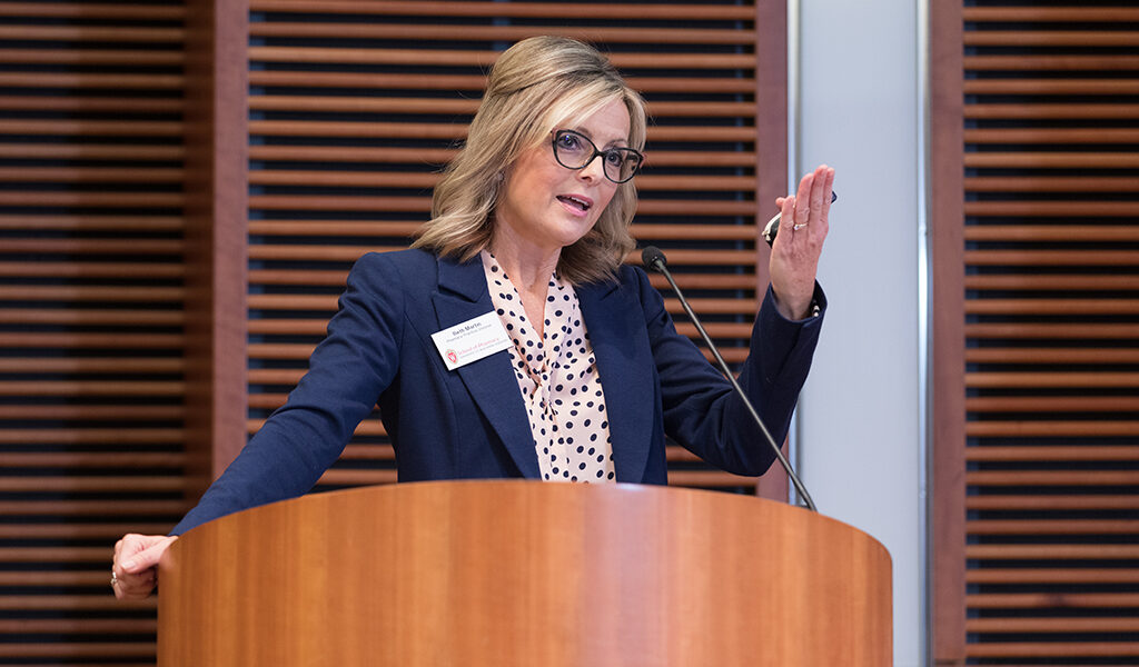 Beth Martin speaks at a podium