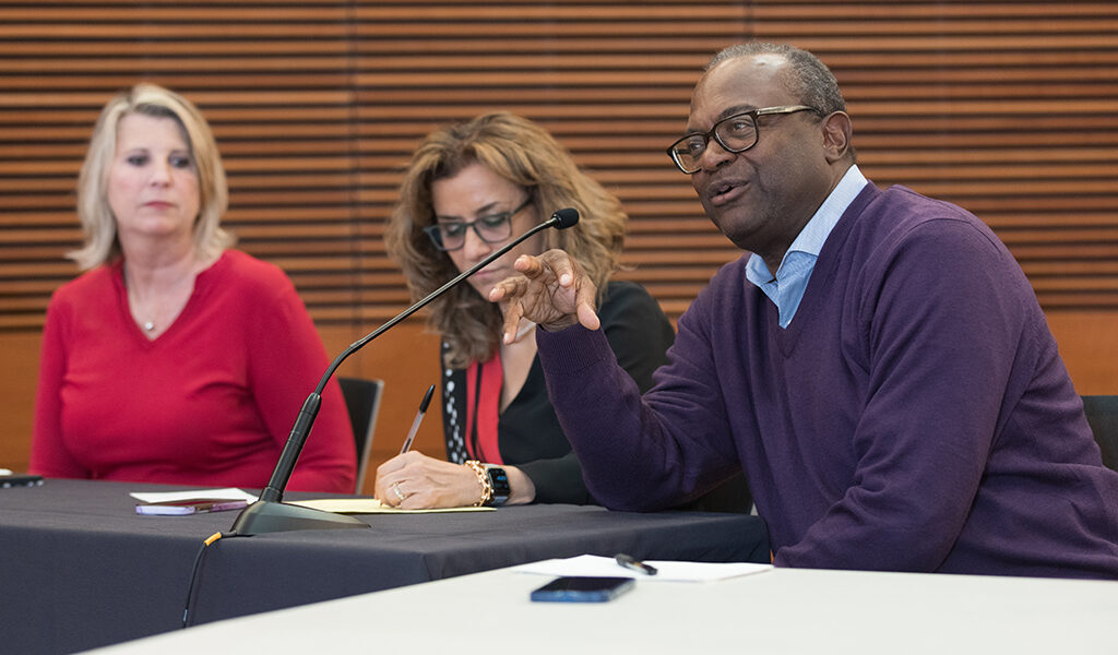 Bruce Scott gives feedback to a presentation next to Debra Fluno and Azita Saleki Gerhardt