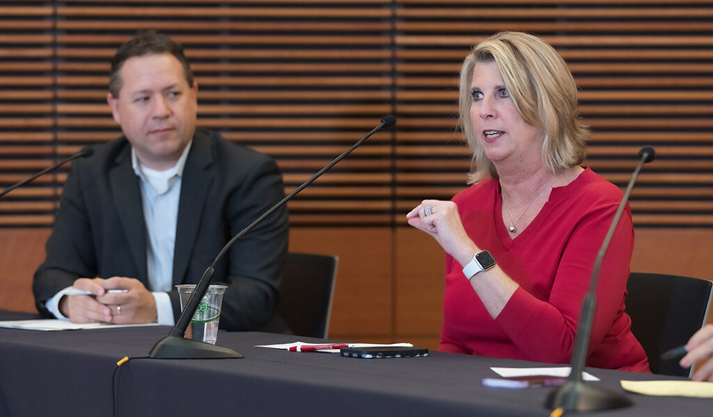 Debra Fluno gives feedback to a presentation next to Brent Eberle