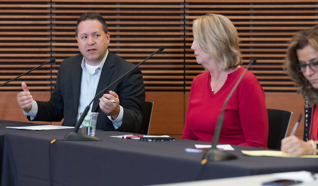 Brent Eberle gives feedback to a presentation next to Debra Fluno
