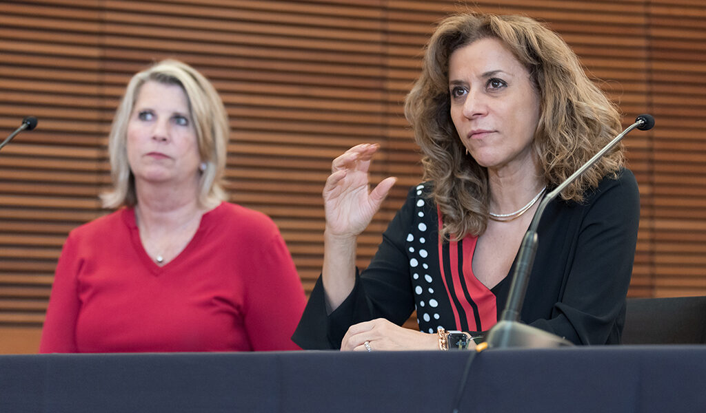 Azita Saleki Gerhardt speaks next to Debra Fluno