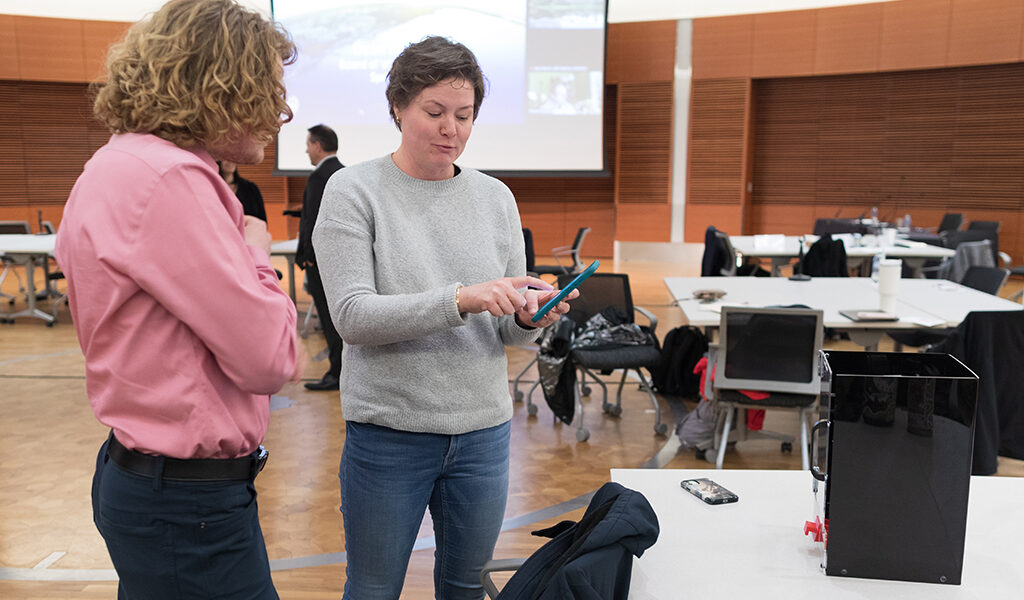 Riley Norman speaks with an attendee