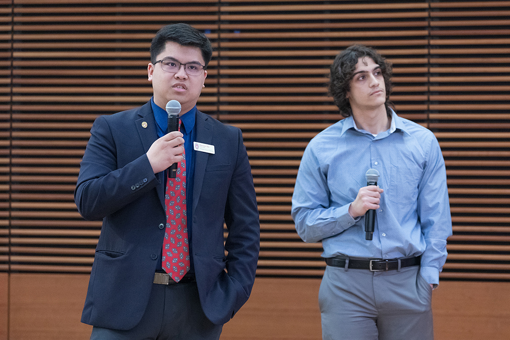 Steven Do and Mohamed Mohamed hold microphones
