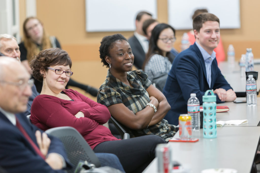 UW School of Pharmacy inagural "SHARx Tank" event - April 20, 2018 Assistant Professor Olufunmilola Abraham (center) , with Rebecca Beebe (left), and Tom Pierson listening to speaker