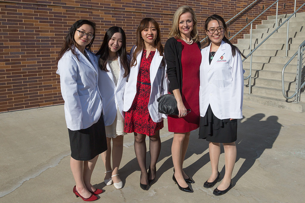 phar042218_071 Pharmacy students Chunxi Zhou, Jiaying Zhang, Mengqi Zhang, and Trinh Trinh pose with Professor Beth Martin following the 2018 Pharmacy White Coat Ceremony.