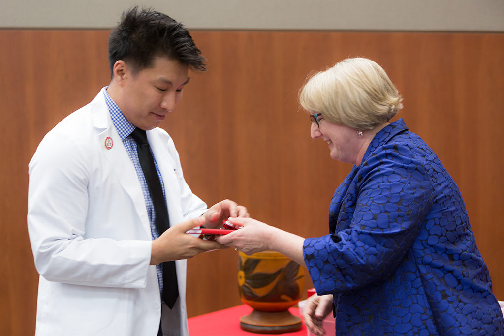 phar050219_039 Associate Professor Karen Kopacek awards the pin to the students.