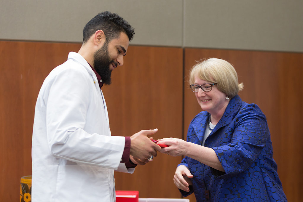 phar050219_043 Associate Professor Karen Kopacek awards the pin to the students.