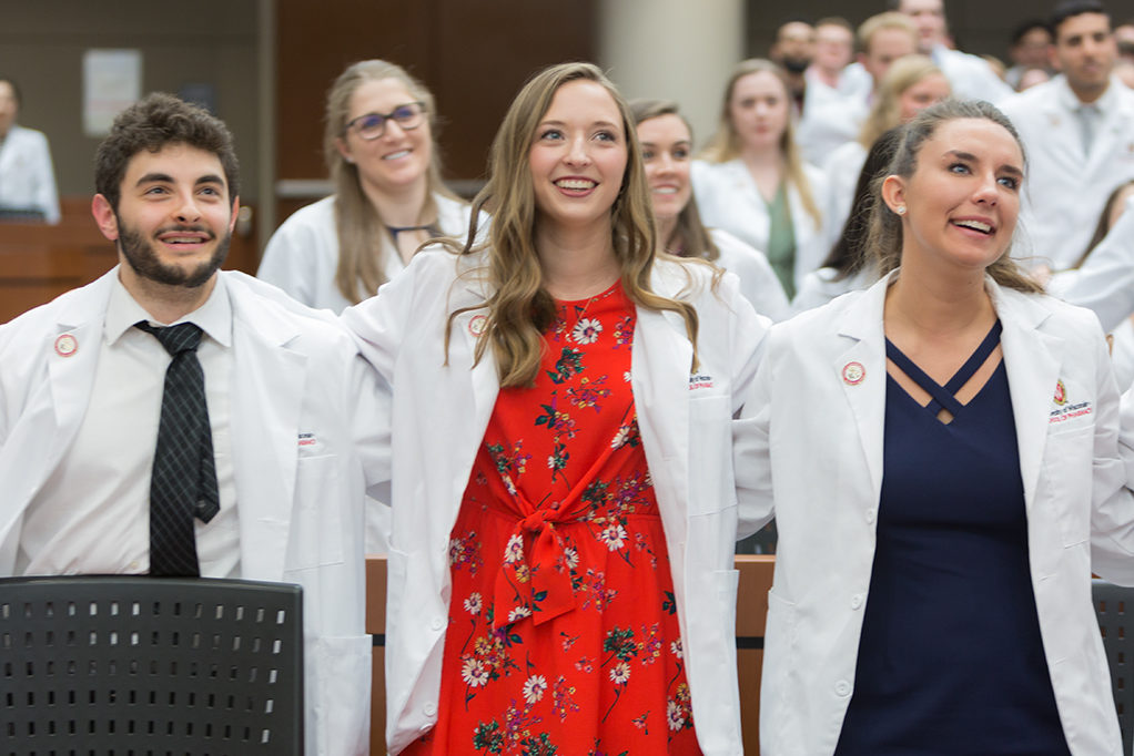 phar050219_069 Student pharmacists locking arms during the ceremony