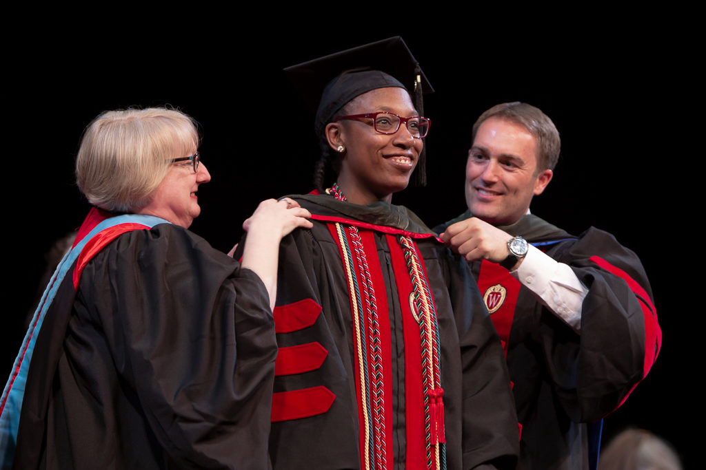 phar051019_015 Students receive the hood for their graduation.