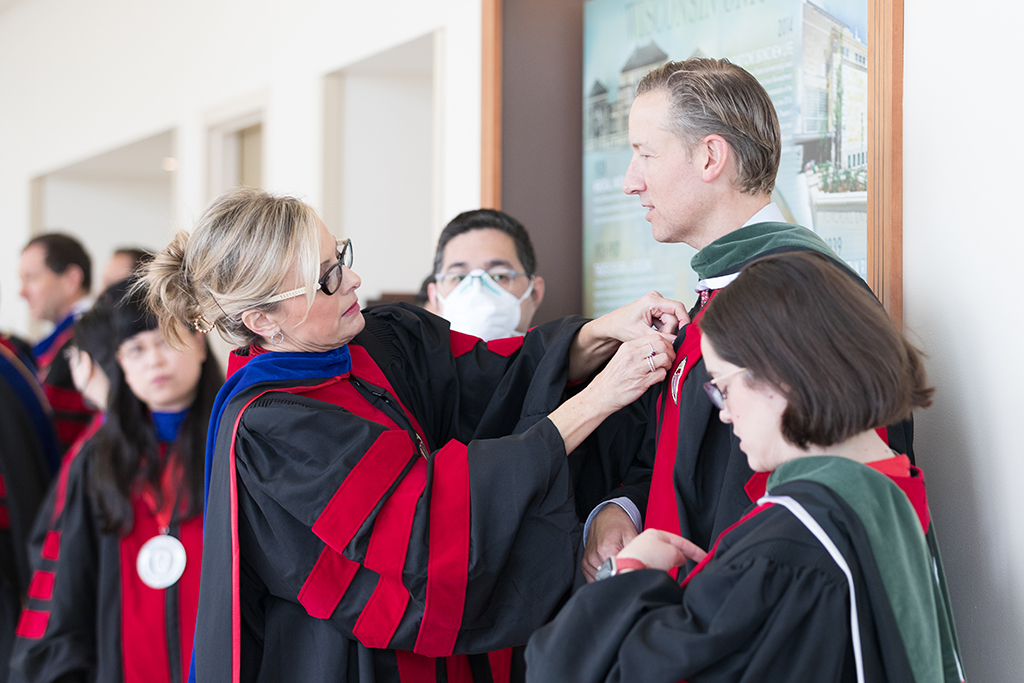 Beth Martin, John Dopp, and Amanda Margolis await the Hooding Ceremony.