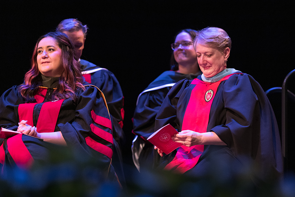 Marina Maes and Karen Kopacek sit onstage.