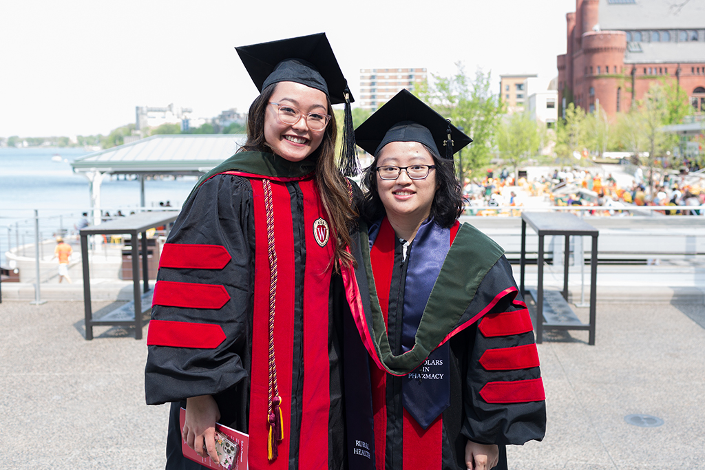 phar051322_160 PharmD Class of 2022 graduates Lorewell Buaya and Kathy Chao pose together on Memorial Union Terrace following the 2022 Hooding Ceremony.