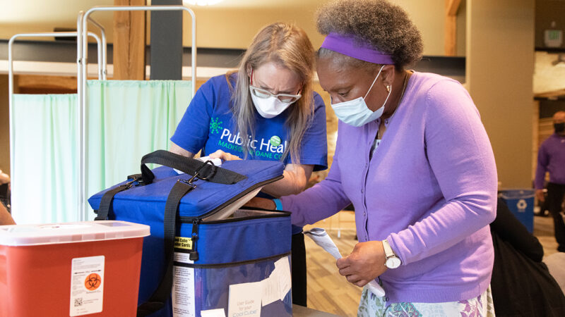 AAHN Outreach and Vaccination Clinic with Eva Vivian, PharmD, MS, PhD Professor Eva Vivian working with Sheryl Johnson at table in vaccination clinic