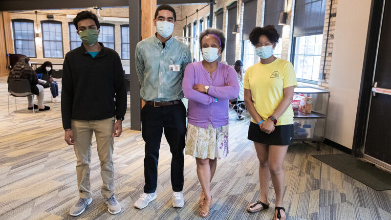 AAHN Outreach and Vaccination Clinic with Eva Vivian, PharmD, MS, PhD Professor Eva Vivian wearing masks with students in vaccination clinic